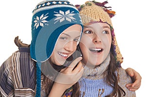 Young girls in warm winter clothes speaking on a mobil