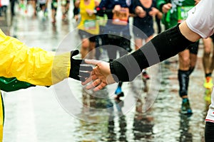 Young give his hand to a runner during the marathon