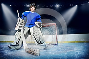 Young goalie in the spotlight of ice hockey arena