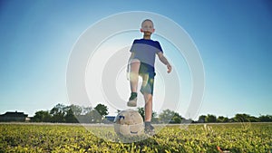 Young goalkeeper with the ball at hand near the goal post.