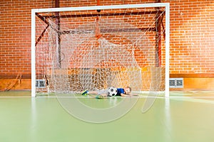 Young goalkeeper diving to save the ball