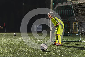 young goalkeeper girl getting ready to catch a ball at a match, young girls team
