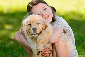 Young golden retriever and girl