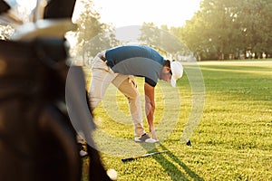 Young golf sportsman warming up exercises