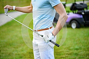 Young golfer holding golf club