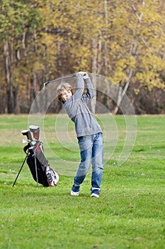 Young golfer swing photo