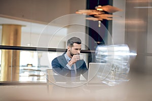 Young good-looking businessman in a nice suit working in the office