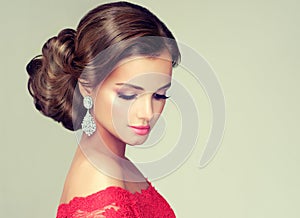 Young, gorgeous model dressed in a red gown.