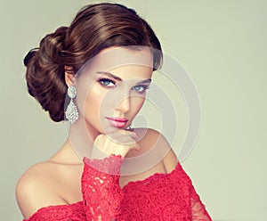 Young, gorgeous model dressed in a red gown.