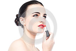 Young gorgeous woman applying lipstick