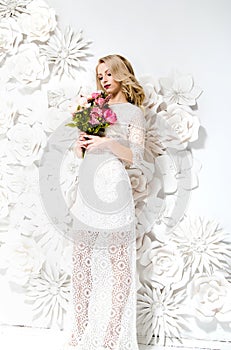 Young gorgeous woman, bride, blond long curly hair, studio decor