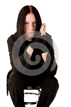 Young goth sitting on a bar chair