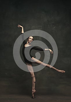 Young and graceful ballet dancer  on dark background. Art, motion, action, flexibility, inspiration concept.