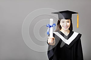 Young graduate showing the diploma