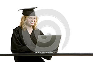 Young graduation girl using computer