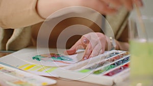 Young graphic designer working on modern desktop computer while using graphic tablet at desk in the office