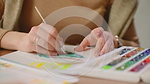 Young graphic designer working on modern desktop computer while using graphic tablet at desk in the office