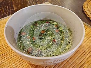 Young green barley or chlorella green food in the cup or bowl.