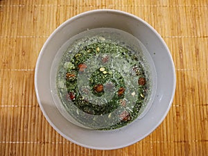 Young green barley or chlorella green food in the cup or bowl.