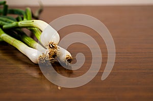 Young green onions on a wooden table. Healthy food