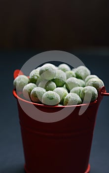 Young green peas in a small bucket on the tableTasty and healthy food