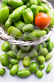 Young green tomatoes in a basket