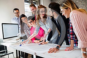 Young group of architects discussing business plans