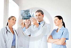 Young group of doctors looking at x-ray