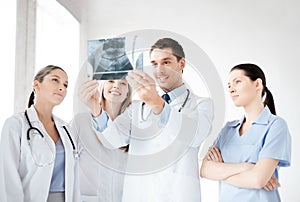 Young group of doctors looking at x-ray