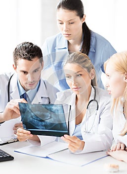Young group of doctors looking at x-ray
