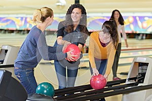 Young group friends in bowling alley