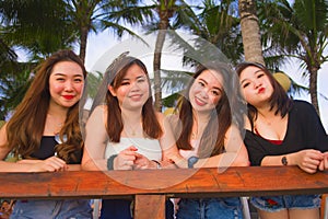 Young group of happy and beautiful Asian Chinese girls having holidays together hanging out enjoying at tropical resort in friends
