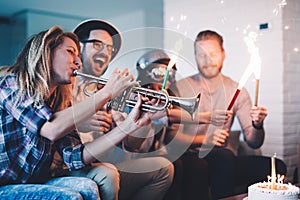 Young group of happy friends celebrating birthday