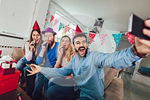 Young group of happy friends celebrating birthday