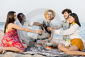 Young group of happy friends enjoying summer vacation at the beach