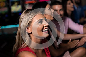 Group of People at Automat Machine in Casino