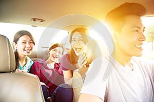 Young group people enjoying road trip in the car