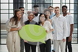 young group of people holding speech bubbles in modern office