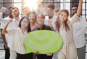 young group of people holding speech bubbles in modern office