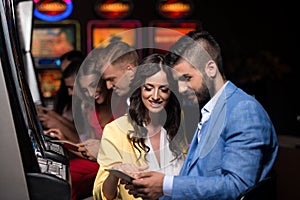 Young Group Playing Automat Machine in a Casino