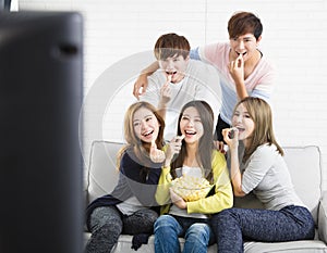 Young group Sitting On Sofa Watching TV