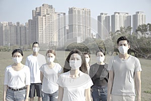 Young group wearing mouth mask against air pollution in city