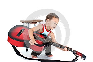 Young guitar player 4 year old on a white background