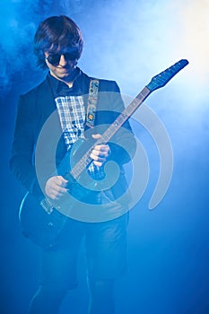 Young guitarist performing on stage