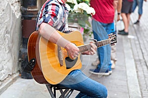 Young guitarist playing in the street