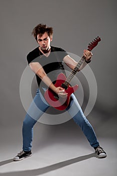 Young guitarist plays on the electric guitar