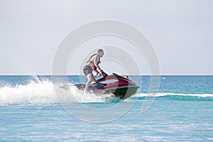 Young guy cruising on a jet ski