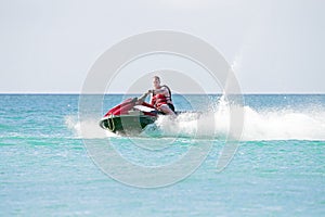 Young guy cruising on a jet ski
