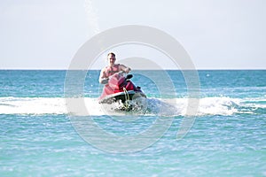 Young guy cruising on a jet ski