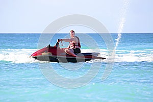 Young guy cruising on a jet ski